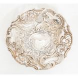 A Victorian silver circular fruit bowl, chased with scrolling foliage and openwork design, on raised