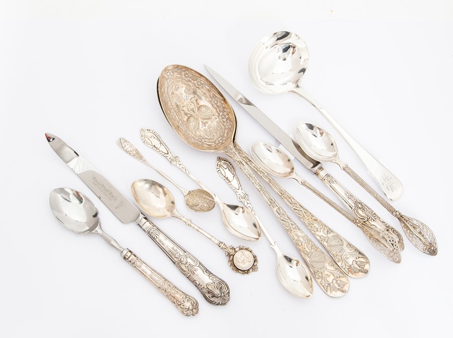 A collection of silver and white metal flatware including: a pair of Continental berry spoons, the