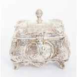 A late Victorian silver tea caddy, bombe shaped profusely chased with scrolling foliage and acanthus