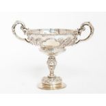 An Edwardian silver two handled cup on stand, the ogee bowl with beaded rim above S scroll floral