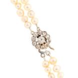 A natural pearl and diamond set necklace, comprising a double strand of graduated off round