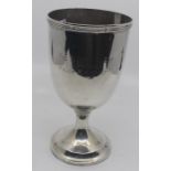 An Edwardian large goblet, reeded rim and lower section on plain raised stepped foot, the plain body