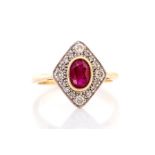 A ruby and diamond 18ct gold ring, the central oval rub over set ruby measuring approx 6.5mm x 4.