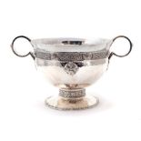 An Arts & Crafts silver Celtic Revival large two handled cup, hammered bowl with a band of