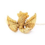 An 18ct gold filigree eagle brooch, the bird depicted in motion, circa 1890, the reverse plate