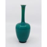 A Bretby art pottery blue monochrome bottle vase. 20 cm tall. (1) Condition: In good overall