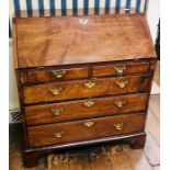 A George III mahogany bureau, circa 1820, fall front enclosing pigeon holes, small drawers and