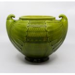 A Bretby Art Pottery twin handled jardiniere after a design by Christopher Dresser, green glaze,
