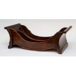A George III mahogany cheese cradle, circa 1810, with a central divider, 45cm long, 22cm wide.