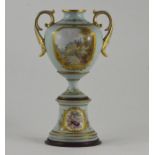 An early 19th Century hand painted two handled pedestal vase, possibly Derby, with panels of