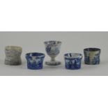 A collection of five early nineteenth century blue and white transfer printed egg cups, circa 1810-