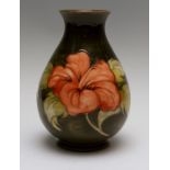 A Moorcroft coral hibiscus baluster vase, impressed marks, Queen Mary paper label, height 21cm