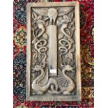 A 20th century Arts & Crafts carved oak wall panel, depicting exotic bird, dragons and snakes in a
