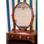 A George III mahogany dressing mirror, circa 1820, oval shaped mirror attached to scrolled