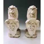 A pair of late 19th Century painted stone carved Lions, holding a shield with carved decorating