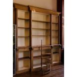 A Victorian style stained pine breakfront bookcase, moulded cornice on turned columns enclosing
