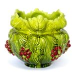 A Bretby Art Pottery jardiniere with heavily moulded grape vine and grape decoration with red and