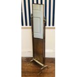 A 19th Century style brass dressing mirror, lion finals on fluted supports holding a long