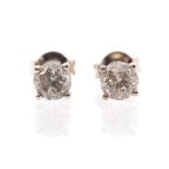A pair of diamond and 18ct white gold stud earrings, the round brilliant cut diamonds weighing a