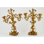 A pair of Neo-rococo gilt metal two branch candelabra, mid 19th Century, each measuring 32cm