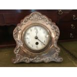 An Edwardian silver faced desk clock, Birmingham 1905, makers mark ‘J.G.’ the silver cast with