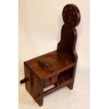 A mid 19th Century grained pine shoe shiners stool, circa 1850, pawn shaped back rest with