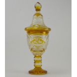 A 19th Century Bohemian amber flashed glass covered urn, facet cut finial, the vessel with a lozenge