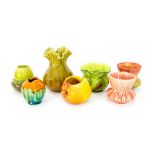 A group of Bretby art pottery vases with various glazes in different forms including an apple and an