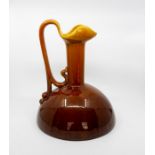 A Bretby Art Pottery large ewer in the manner of Christopher Dresser, graduated ochre glazes, No.