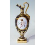 A Mintons hand painted ewer, early 20th Century, with foliage decoration on a blue ground, with a