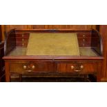 A William IV mahogany tambour cylinder top writing desk, circa 1830, in the manner of Gillows