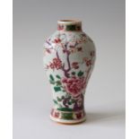A Chinese Yongzheng porcelain baluster vase, painted with a blossom branch in polychrome enamels,