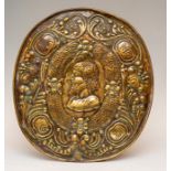 A 17th Century repousse brass wall sconce back plate, central oval portrait medallion of a bearded