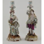 A pair of 19th Century Continental figural candleholders, depicting a man with a hat and a woman