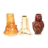 A group of three Bretby art pottery modelled vases. No 293 as a dragon wrapping around the vase,