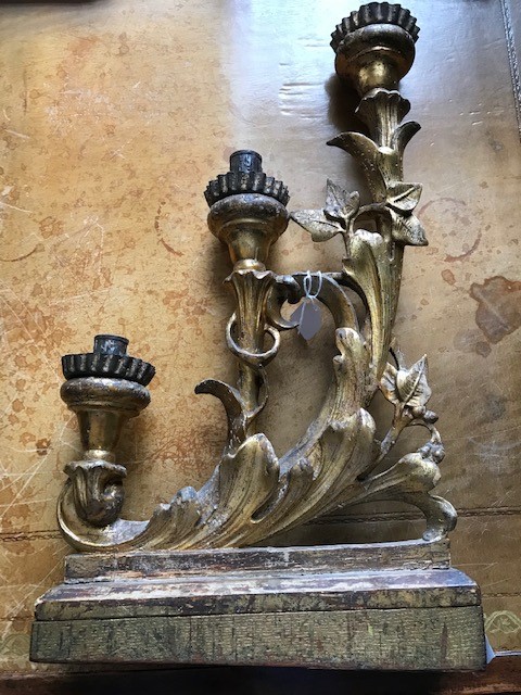 A pair of 18th Century Florentine gilt gesso triple branch candelabra, of scroll design, on wooden