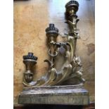 A pair of 18th Century Florentine gilt gesso triple branch candelabra, of scroll design, on wooden