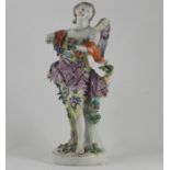 A 19th Century Sampson figure of a Classical maiden, with wings, holding a wreath of flowers, anchor