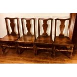 A set of four mid 18th Century mahogany dining chairs, pierced urn shaped splat back, raised on
