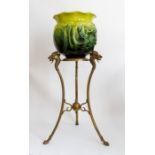 A Bretby Art Pottery large jardiniere on a brass stand, the stand with three detailed dragon heads