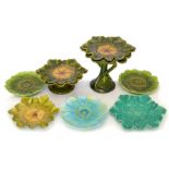 A group of Bretby art pottery green glazed dessert wares with floral decoration and two similarly
