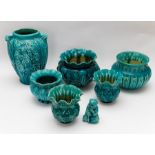 A group of Bretby art pottery turquoise glazed bowls, planters a vase and a decorative monkey