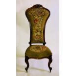A 19th Century walnut prie-dieu chair, carving floral top with tapestry floral seating and back,