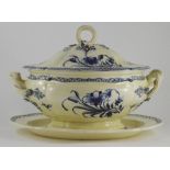 A blue and white hand-painted creamware soup tureen, cover and stand, circa 1810. It is decorated