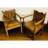 A near pair of early 20th century oak armchairs, scrolled finials and top back rest above five