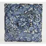 A 19th Century Chinese blue and white square tile, a central roundel framed by scrollwork, 19.5cm