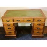 An early 20th Century oak pedestal desk, rectangular top with leather inlay writing surface,
