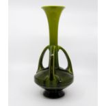 A Bretby Art Pottery Arts & Crafts triple handled trumpet vase, graduated green glaze, No.1558C,