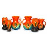 A group of Bretby Art Pottery vases all similarly styled and decorated with stylised flower