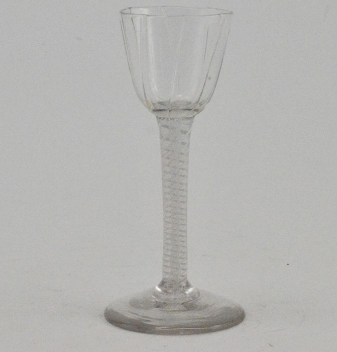 A George III hand blown cordial glass, circa 1770, the wrythen bowl raised on a double airtwist